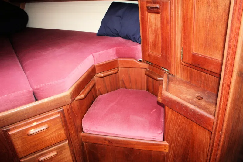 Slide: The Image of Cozy wooden cabin interior with red cushions on a 1991 Ericson 380 sailboat. - 27