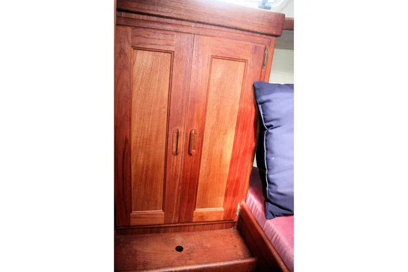 Slide: The Image of Wooden cabinet with double doors inside a 1991 Ericson 380 sailboat cabin. - 29