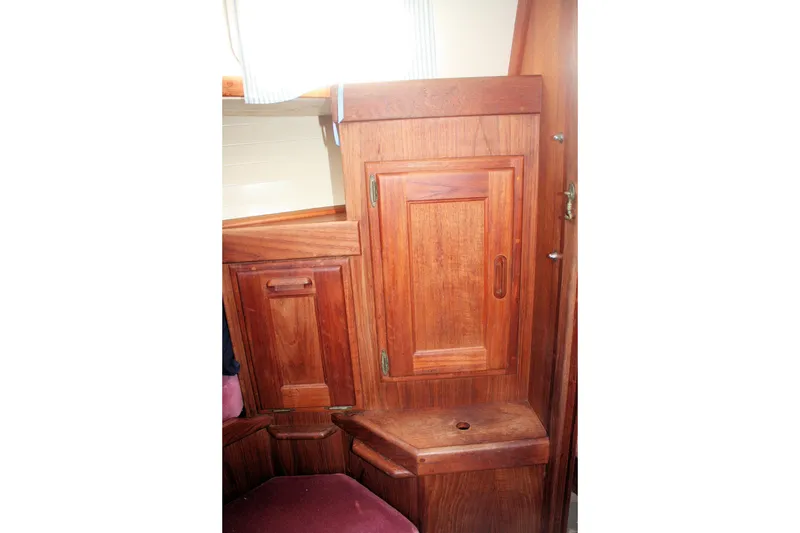 Slide: The Image of Interior wooden cabinetry of a 1991 Ericson 380 sailboat, featuring rich wood tones. - 30