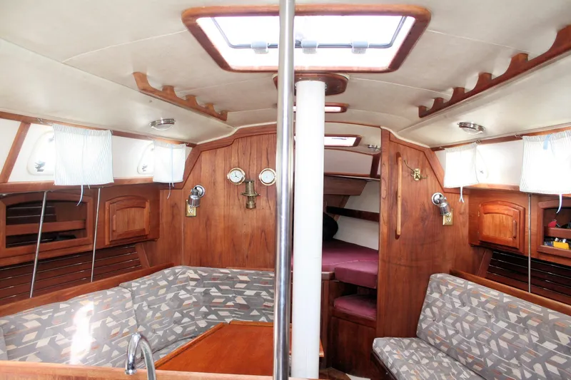 Slide: The Image of Interior of a 1991 Ericson 380 sailboat with wood paneling and seating area. - 32