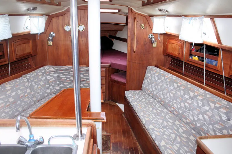 Slide: The Image of Interior of a 1991 Ericson 380 sailboat with wood paneling and patterned seating. - 33