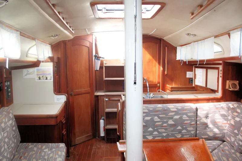 Slide: The Image of Interior of a 1991 Ericson 380 sailboat with wood finishes and patterned seating. - 40