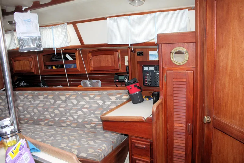 Slide: The Image of Interior of a 1993 Ericson 38-200 sailboat with wooden cabinetry and seating area. - 42