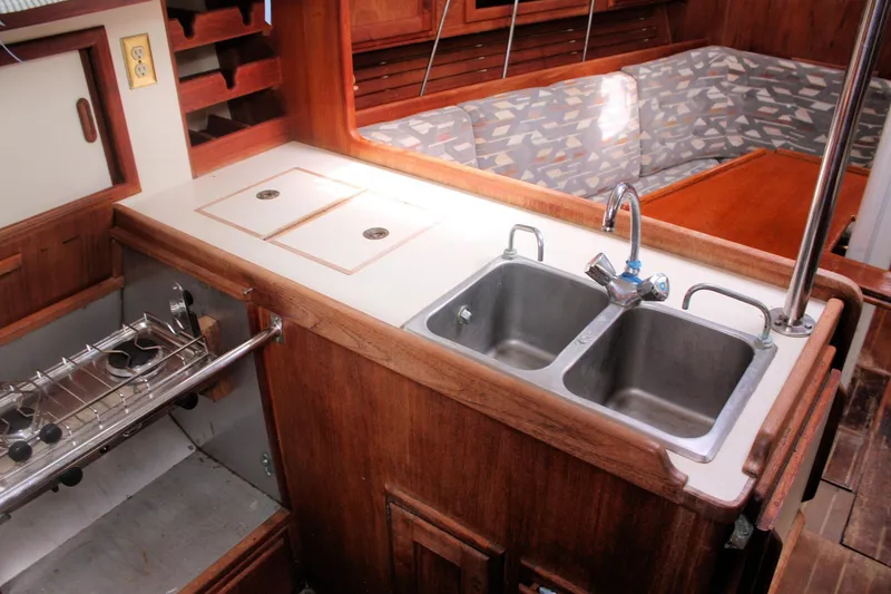 Slide: The Image of Interior of 1991 Ericson 380 sailboat galley with dual sinks and wooden cabinetry. - 43