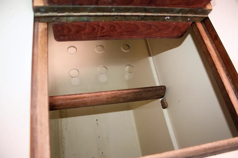Slide: The Image of Open wooden storage compartment on a 1991 Ericson 380 sailboat. - 48