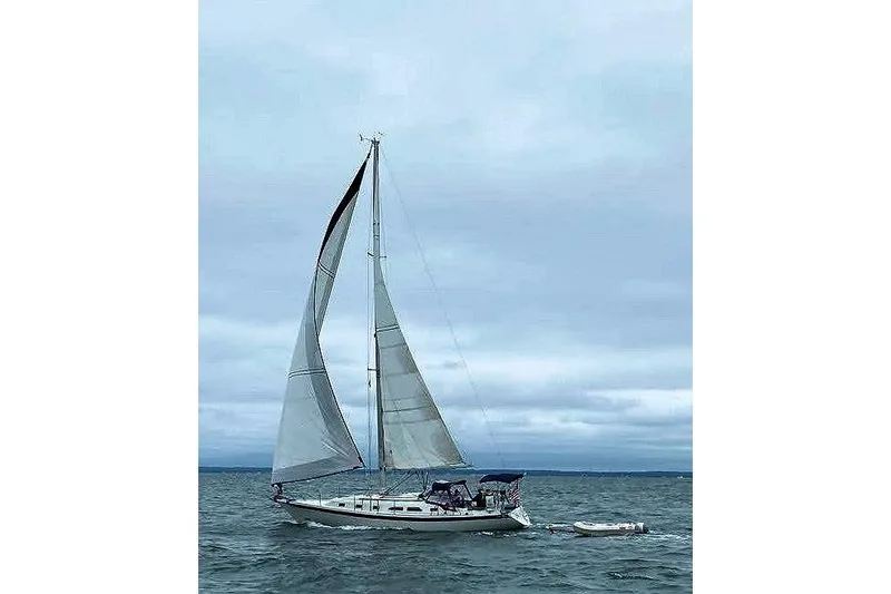 Slide: The Image of Sailing yacht Ericson 38-200, 1993 model, cruising on open water under cloudy skies. - 5