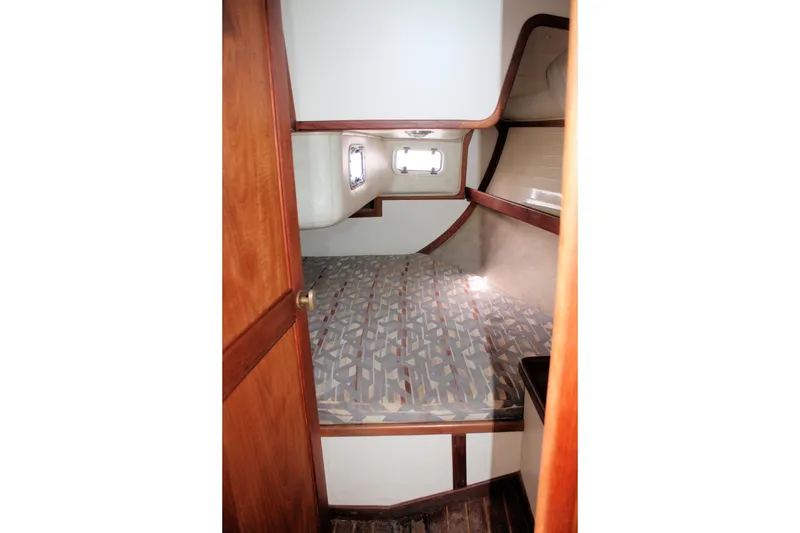 Slide: The Image of Interior cabin of a 1991 Ericson 380 sailboat with patterned bedding and wooden accents. - 50