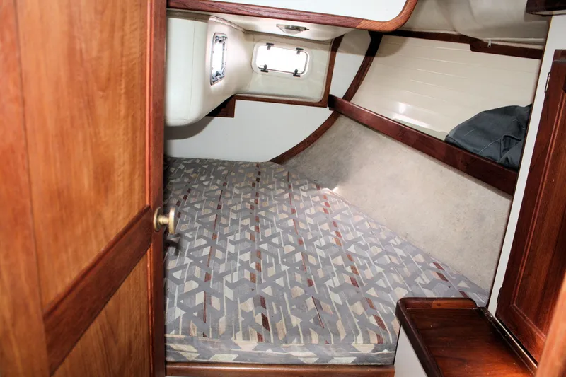 Slide: The Image of Cozy cabin interior of a 1991 Ericson 380 sailboat with patterned bedding. - 51