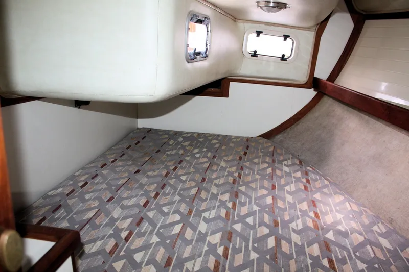 Slide: The Image of Interior cabin of a 1991 Ericson 380 sailboat with patterned flooring and porthole windows. - 52