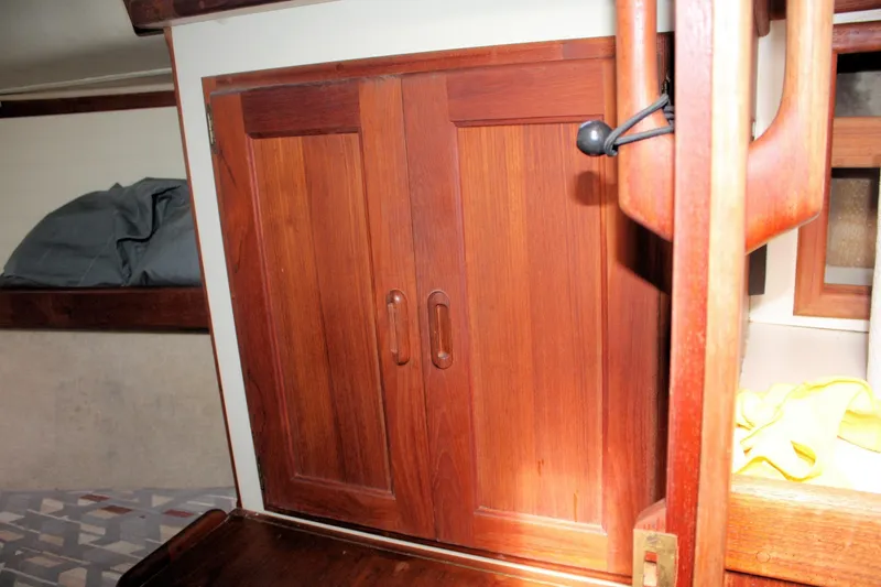 Slide: The Image of Wooden cabinet doors inside a 1991 Ericson 380 sailboat cabin interior. - 53