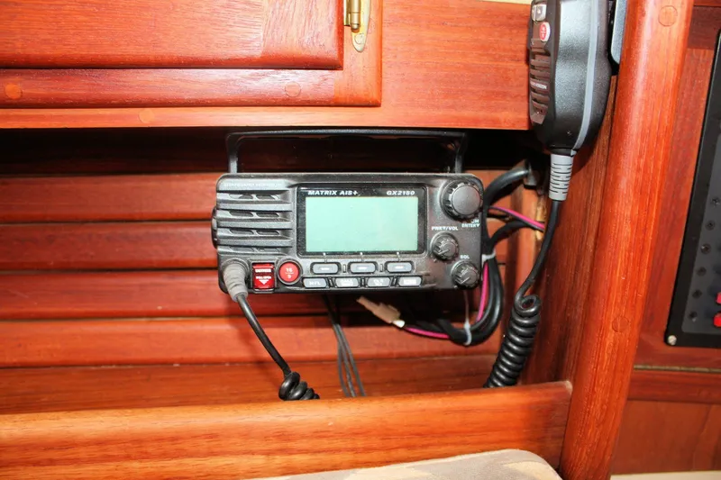 Slide: The Image of Marine radio equipment inside a 1991 Ericson 380 sailboat, featuring a Matrix AIS+ GX2150. - 58