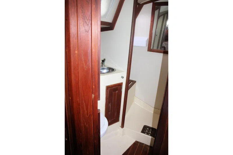 Slide: The Image of Bathroom interior of 1991 Ericson 380 yacht with wooden accents and compact design. - 60