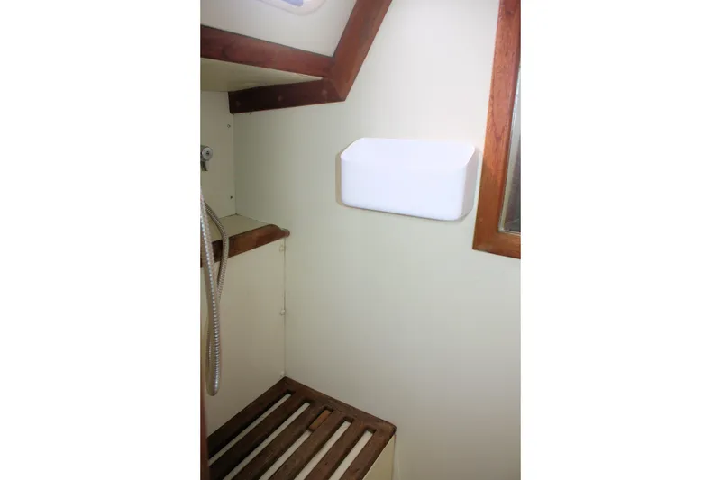 Slide: The Image of Interior of 1991 Ericson 380 sailboat bathroom with wooden accents and showerhead. - 63