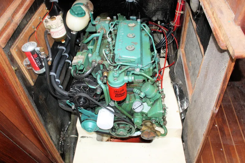 Slide: The Image of Engine compartment of a 1991 Ericson 380 sailboat, featuring a green marine engine. - 64