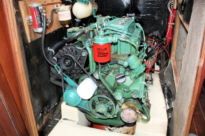Slide: The Image of Engine compartment of a 1991 Ericson 380 sailboat, featuring a green marine engine. - 65
