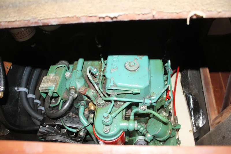 Slide: The Image of Engine compartment of a 1993 Ericson 38-200 sailboat, featuring a green marine engine. - 68