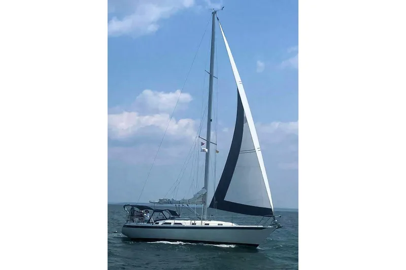 Slide: The Image of Sailing on open water, 1993 Ericson 38-200 yacht with full sails under a blue sky. - 8
