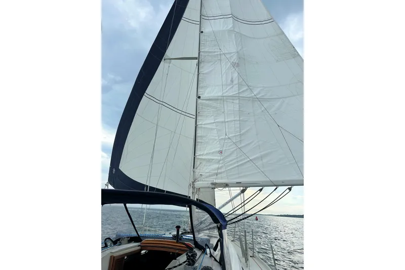 Slide: The Image of Sailing on a 1993 Ericson 38-200 yacht with full sails on a cloudy day. - 9