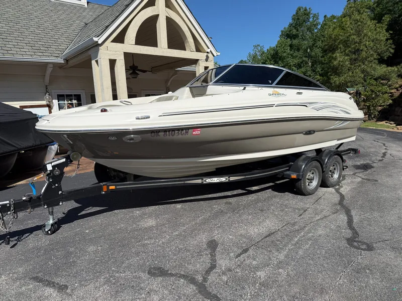 Slide: The Image of 2006 Sea Ray 200 Sundeck on trailer parked in front of house. - 20