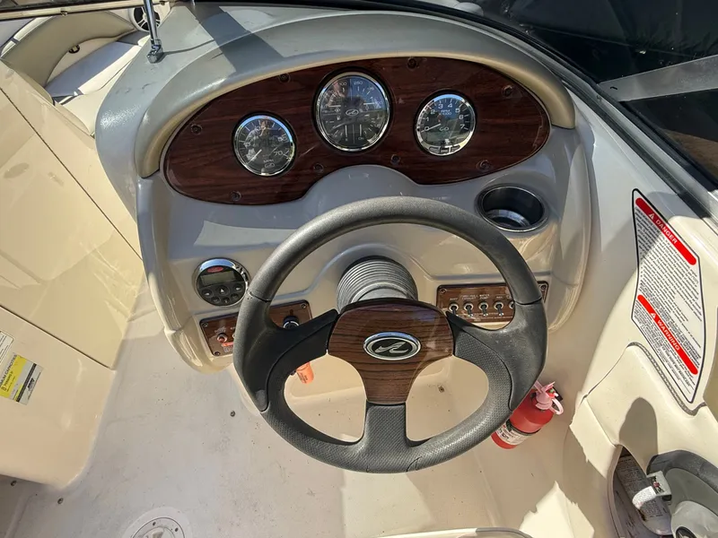 Slide: The Image of Dashboard of a 2006 Sea Ray 200 Sundeck boat with steering wheel. - 27