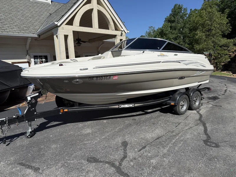 Slide: The Image of 2006 Sea Ray 200 Sundeck on trailer parked in front of house. - 7