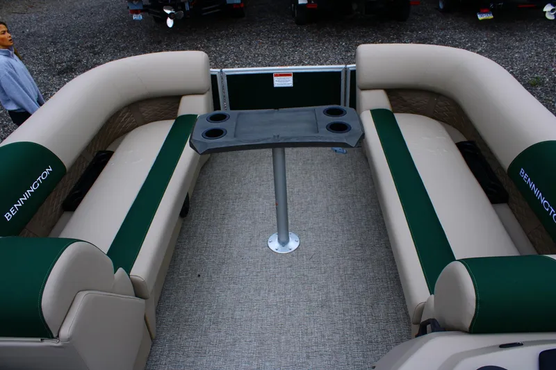 Slide: The Image of Interior of 2026 Bennington 21 SSRSF pontoon boat with beige and green seating. - 4