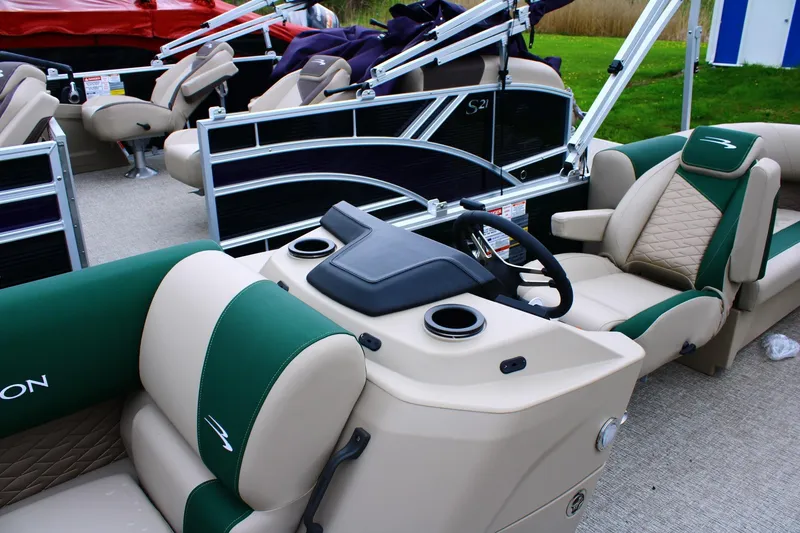 Slide: The Image of 2026 Bennington 21 SSRSF pontoon boat interior with green and beige seating. - 5