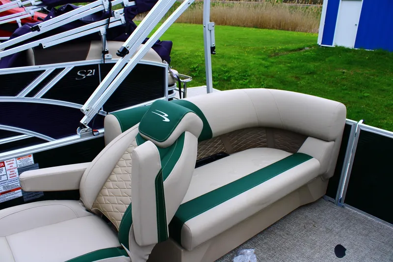 Slide: The Image of 2026 Bennington 21 SSRSF pontoon boat interior with green and beige seating. - 6