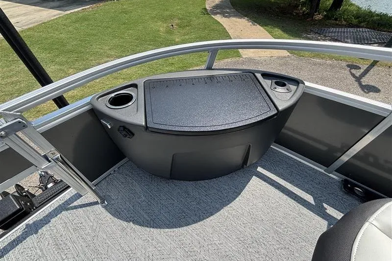 Slide: The Image of 2026 Sun Tracker Bass Buggy 18 DLX pontoon boat interior with storage and cup holder. - 10