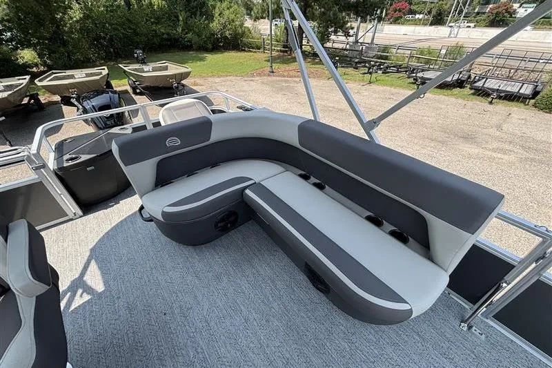 Slide: The Image of 2026 Sun Tracker Bass Buggy 18 DLX pontoon boat with spacious seating and modern design. - 18