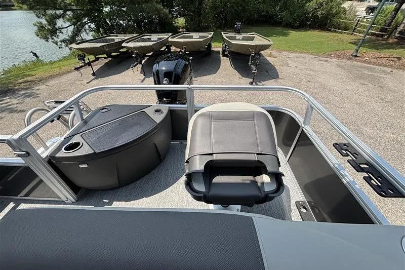 Slide: The Image of 2026 Sun Tracker Bass Buggy 18 DLX pontoon boat interior with seating and console. - 24