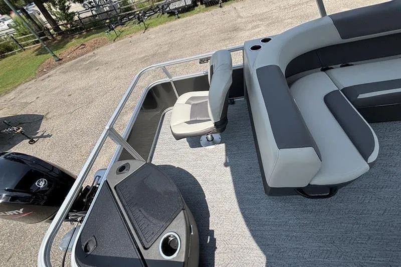 Slide: The Image of 2026 Sun Tracker Bass Buggy 18 DLX pontoon boat interior with seating and console. - 25