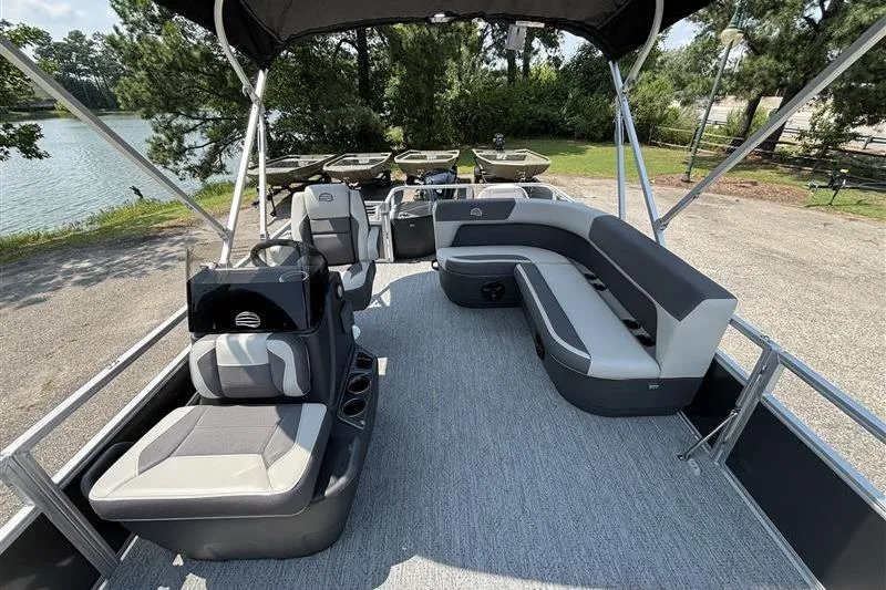 Slide: The Image of 2026 Sun Tracker Bass Buggy 18 DLX pontoon boat with spacious seating and canopy. - 7