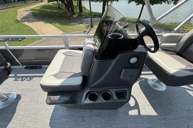 Slide: The Image of 2026 Sun Tracker Bass Buggy 18 DLX pontoon boat interior with steering console and seating. - 16