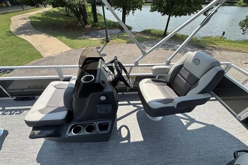 Slide: The Image of 2026 Sun Tracker Bass Buggy 18 DLX pontoon boat interior with steering console and seating. - 15