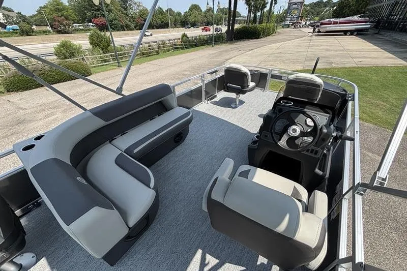 Slide: The Image of 2026 Sun Tracker Bass Buggy 18 DLX pontoon boat interior with seating and steering console. - 19