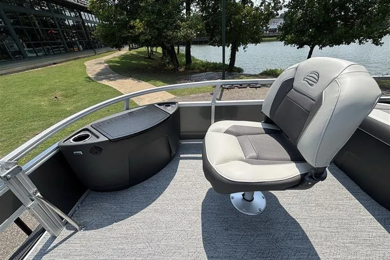 Slide: The Image of 2026 Sun Tracker Bass Buggy 18 DLX pontoon boat interior with seating and storage. - 9