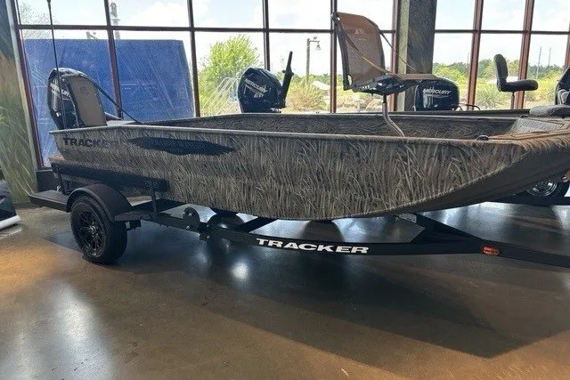 The Image of 2026 Tracker Grizzly 1650 T Prairie Wings Edition boat on display indoors. - 0