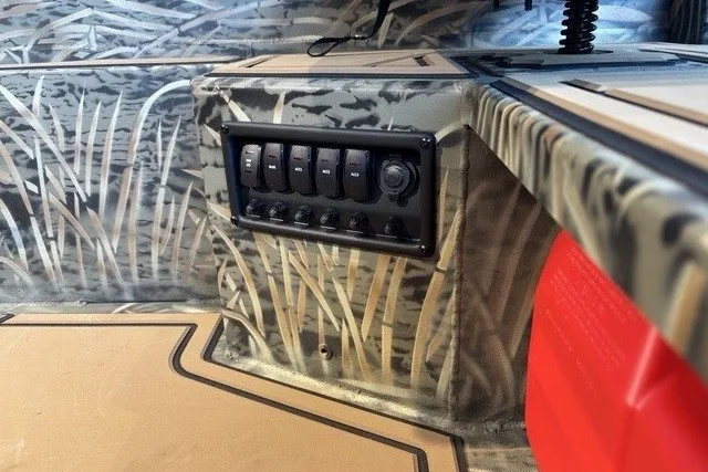 Slide: The Image of 2026 Tracker Grizzly 1650 T Prairie Wings Edition interior with camo design and control panel. - 5