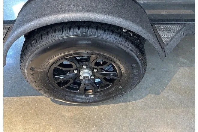 Slide: The Image of Black wheel of 2026 Tracker Grizzly 1650 T Prairie Wings Edition on concrete floor. - 12