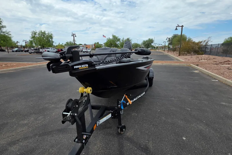 Slide: The Image of 2026 Tracker Super Guide V-16 SC boat on trailer in parking lot. - 2