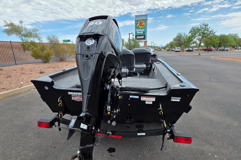 Slide: The Image of 2026 Tracker Super Guide V-16 SC boat with motor, parked outdoors. - 3