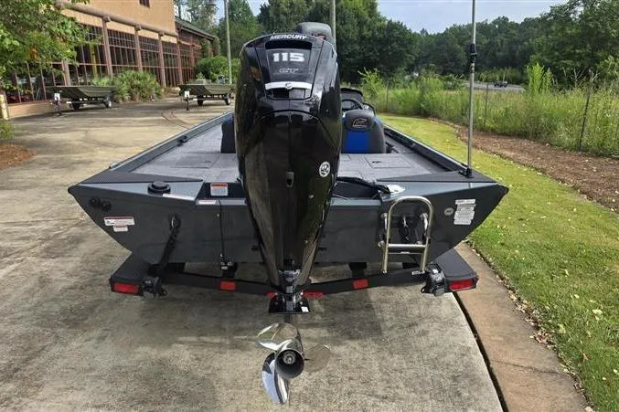 Slide: The Image of 2026 Ranger RT188C boat with Mercury 115 engine, parked outdoors on concrete. - 6
