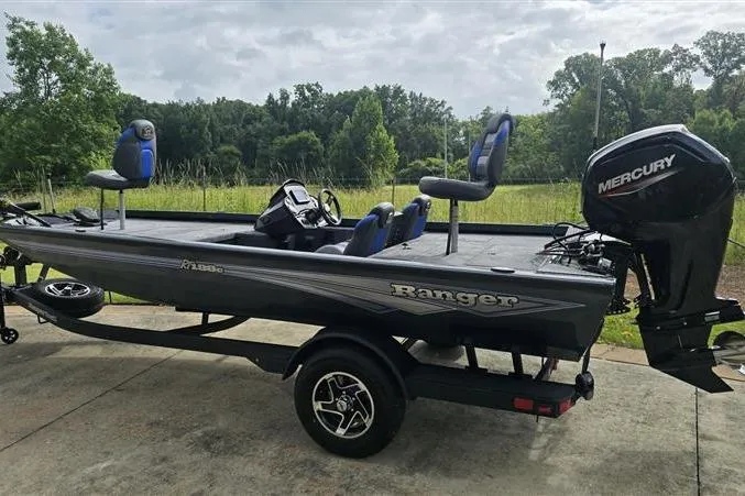 Slide: The Image of 2026 Ranger RT188C fishing boat with Mercury engine on trailer, parked outdoors. - 5