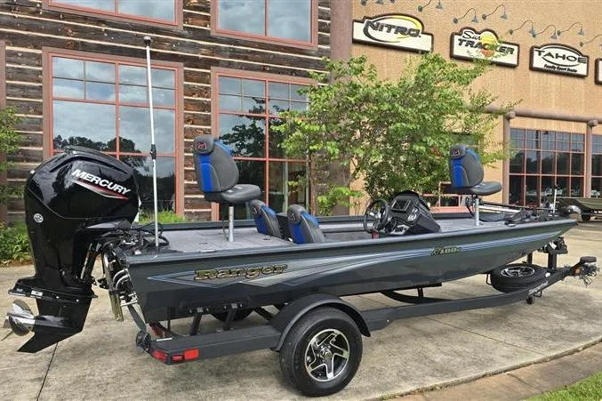 Slide: The Image of 2026 Ranger RT188C fishing boat with Mercury engine, parked outside a dealership. - 7