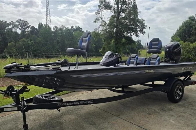 Slide: The Image of 2026 Ranger RT188C fishing boat on trailer, parked outdoors with lush greenery background. - 3