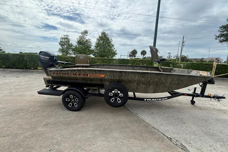 Slide: The Image of 2026 Tracker Grizzly 1756 T Marsh boat on trailer, outdoors, with Mercury engine. - 49