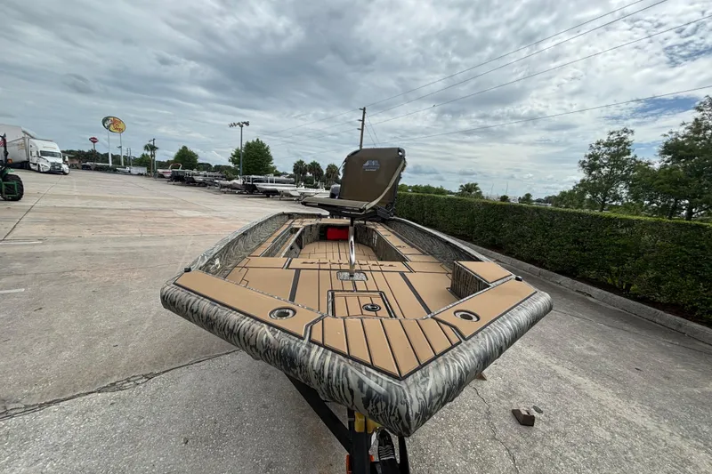 Slide: The Image of 2026 Tracker Grizzly 1756 T Marsh boat on trailer, parked outdoors under cloudy sky. - 52