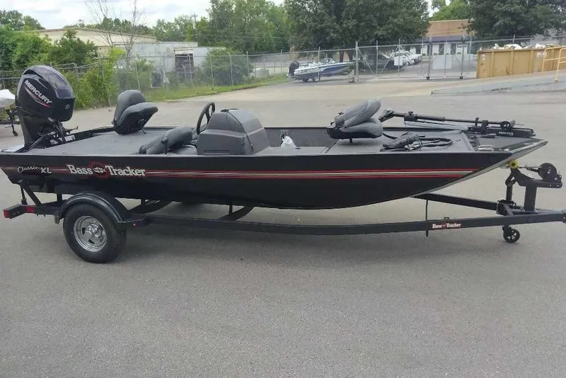 The Image of 2026 Tracker Bass Tracker Classic XL fishing boat on trailer, parked outdoors. - 0
