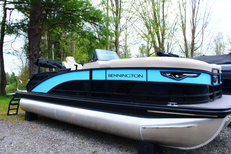 The Image of 2026 Bennington 22MSB pontoon boat with sleek design, parked outdoors. - 1
